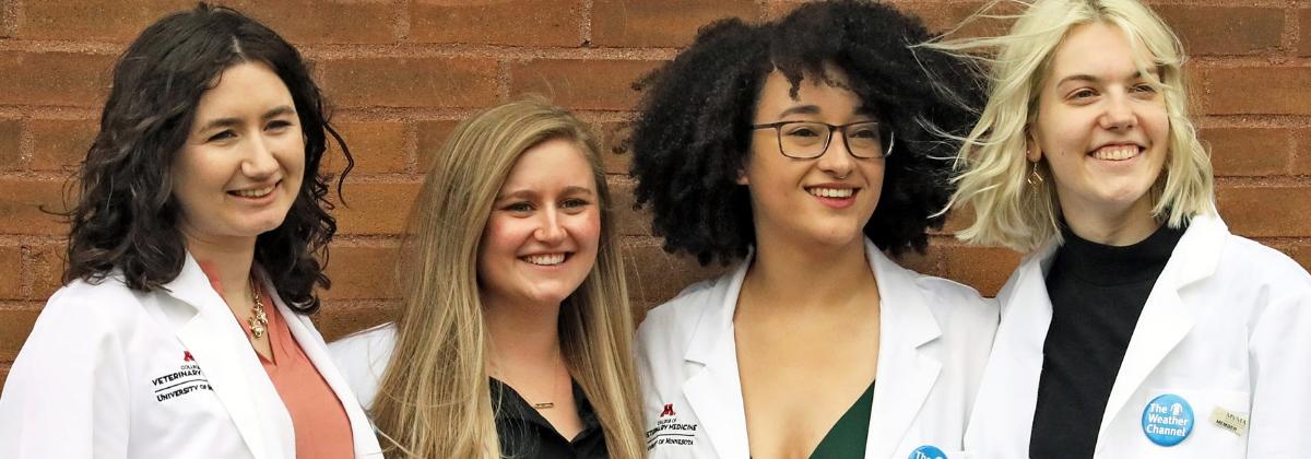 Four students pose for their photo at the White Coat Ceremony