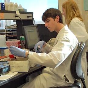 Two students work at a laboratory table