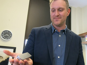 Peter Larsen holding a device in his hand