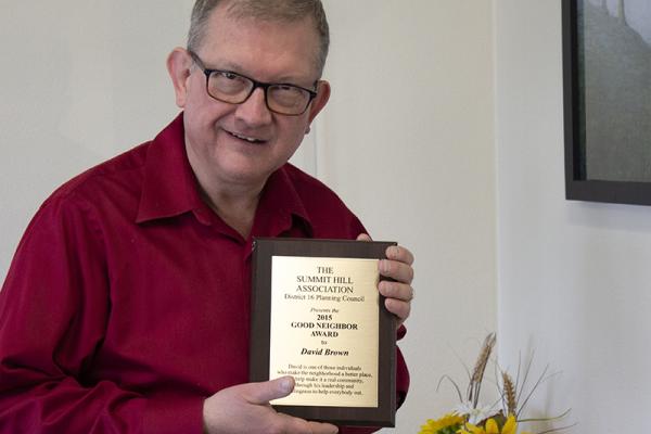 David Brown holding his Good Neighbor Award