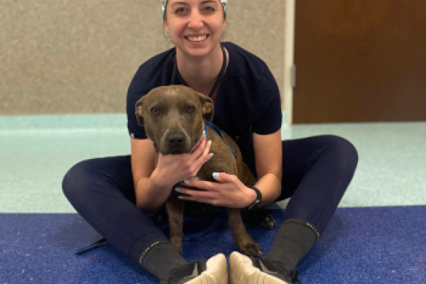 Megan Gates sits with a canine patient